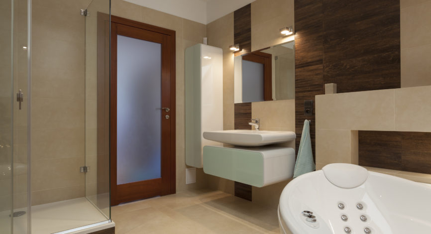 Bathroom with bathtub and a glass shower